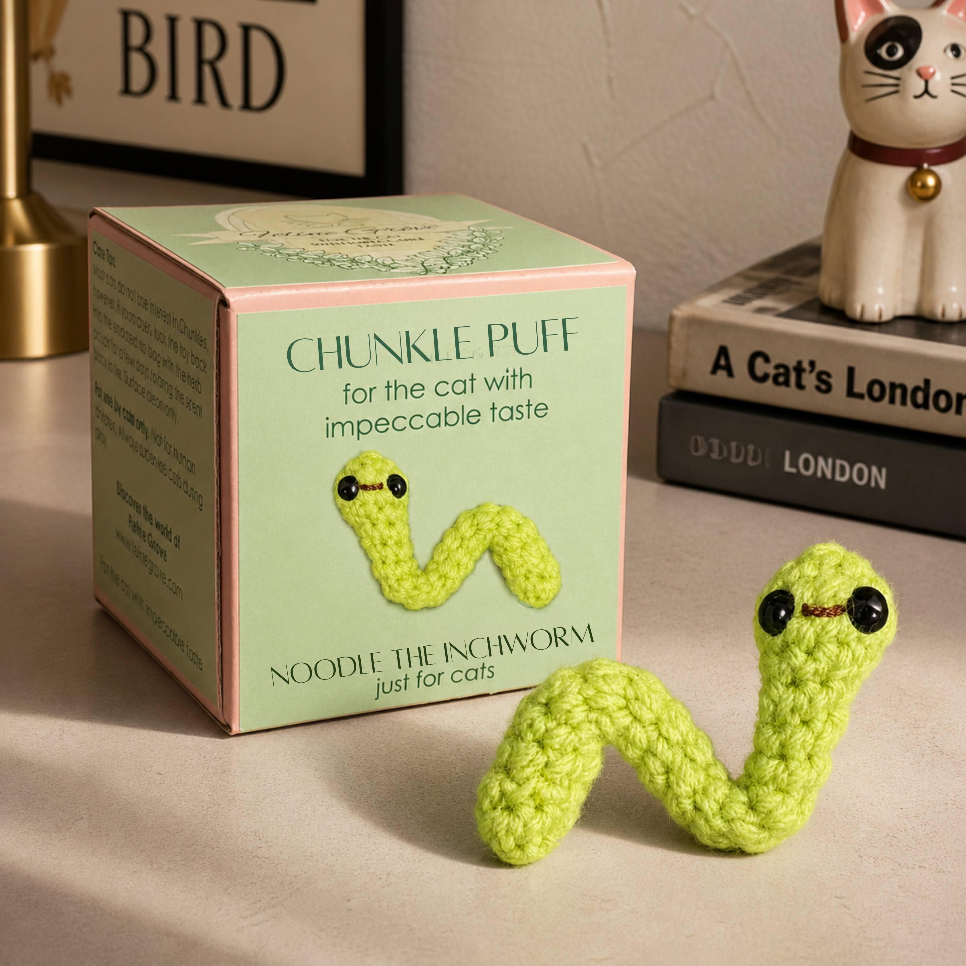 Chunkle Puff box packaging with green woven inchworm cat toy displayed, compact curved shape with soft textured surface, artisan design for batting and carrying, Chunkle & Puff toy infused with Miracle Nip