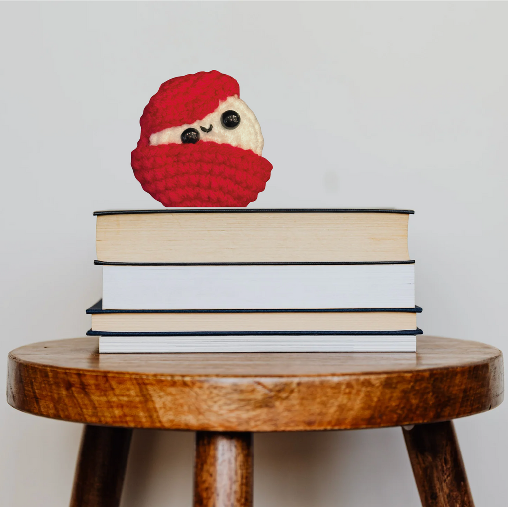 Edom Cheese shaped cat toy by Chunkle & Puff on stack of books