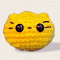 Round yellow weighted Chunkle Chunk cat toy by Chunkle & Puff on white background.