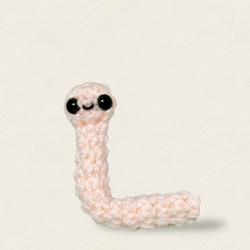 Blush pink woven earthworm cat toy with glossy black eyes, soft textured form and compact shape for batting and carrying, Chunkle & Puff luxury cat toy infused with Miracle Nip by Feline Grove