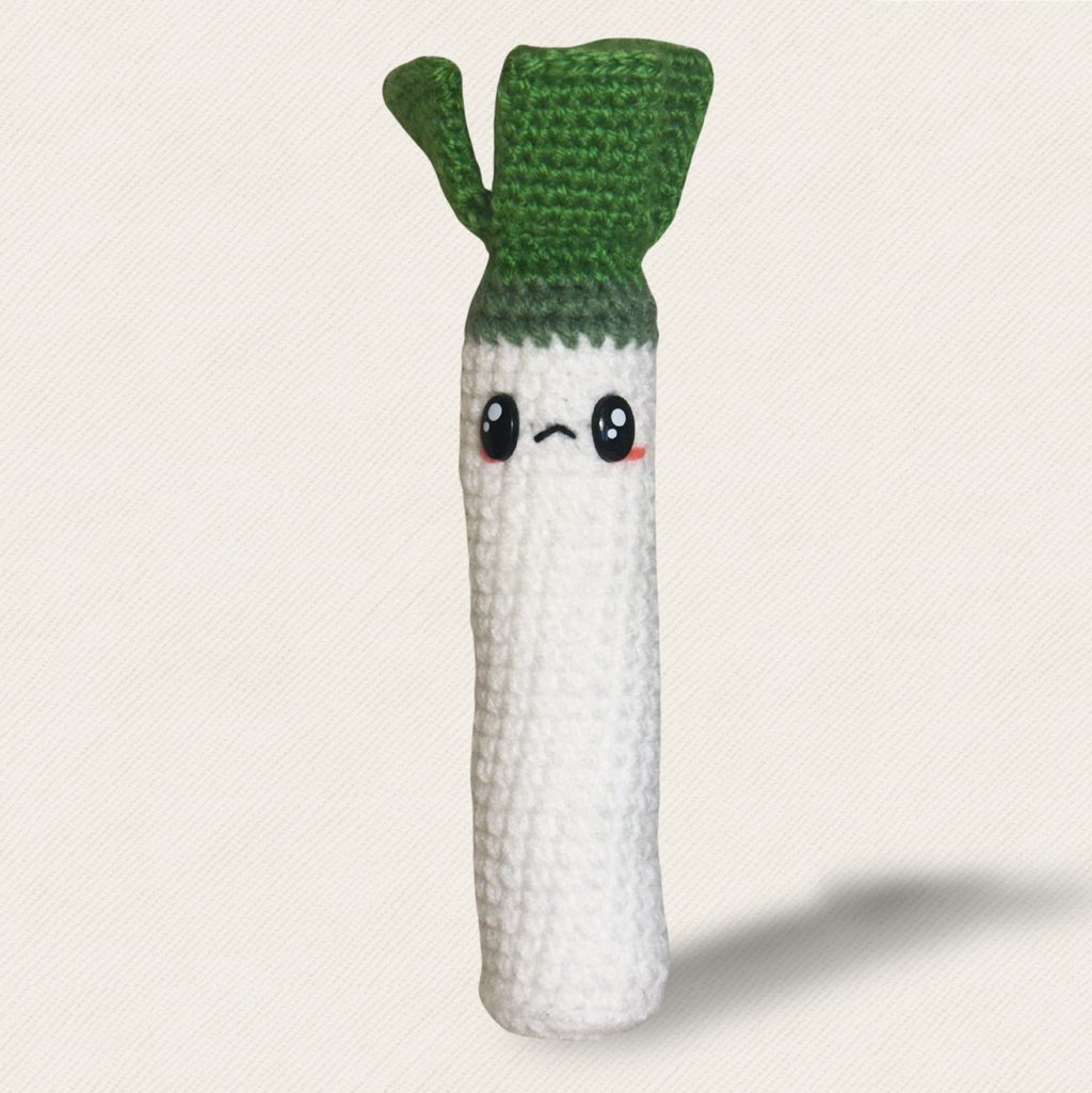 hero image of green and white woven leek shaped cat toy filled with silvervine, valerian, gall fruit, and tatarian honeysuckle botanical blend designed for independent play cat enrichment