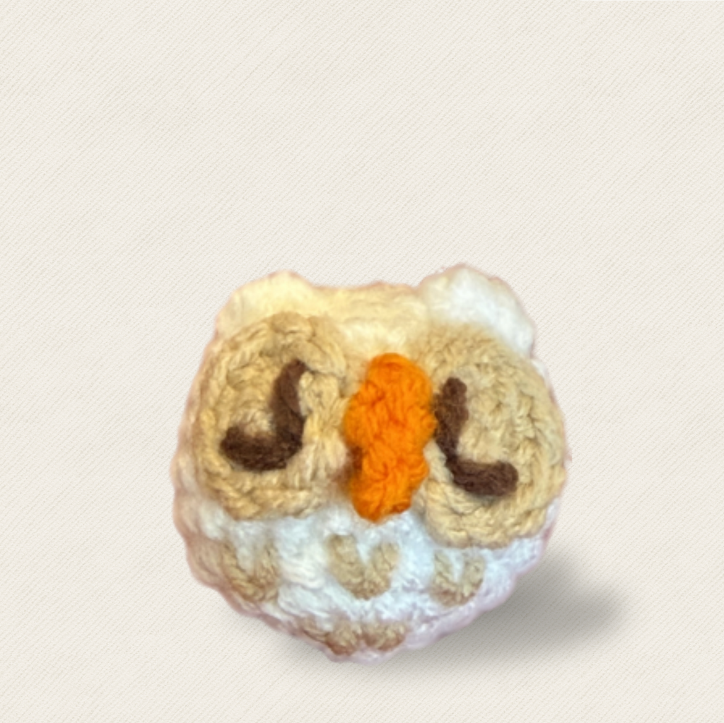 Cat Toy Owl Hero Image. Snow owl shaped woven cat toy front view showing orange beak and brown eye detail, Miracle Nip botanical catnip alternative by Feline Grove.