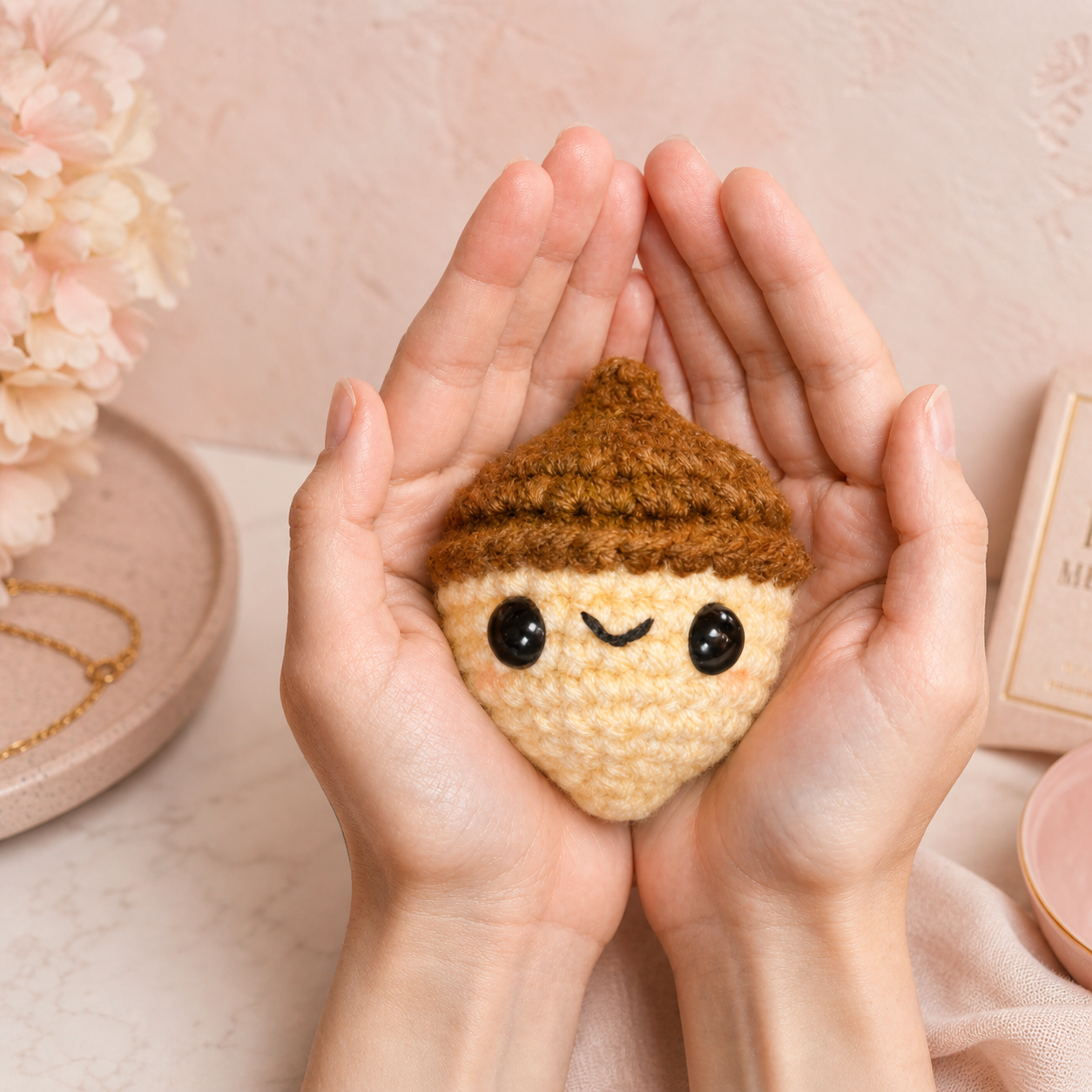 Scale image of Augie the Acorn Chunkle Puff catnip alternative cat toy with hands on peach background.