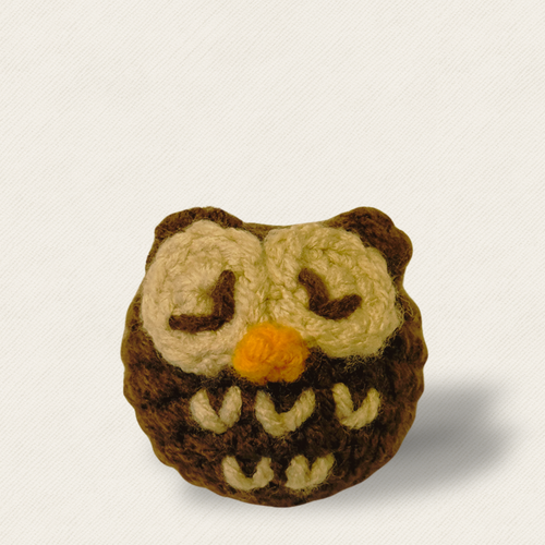 Biscuit the pygmy owl catnip alternative cat toy hero image on light background with dramatic shadow