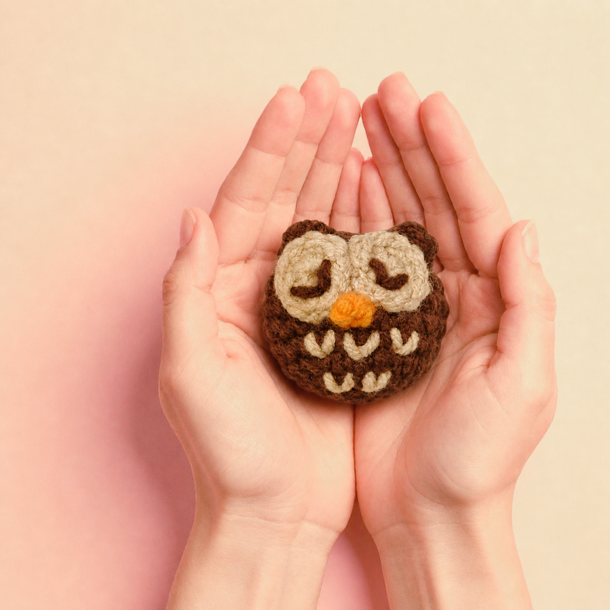 Biscuit the pygmy owl cat toy held in cupped hands to show size of toy
