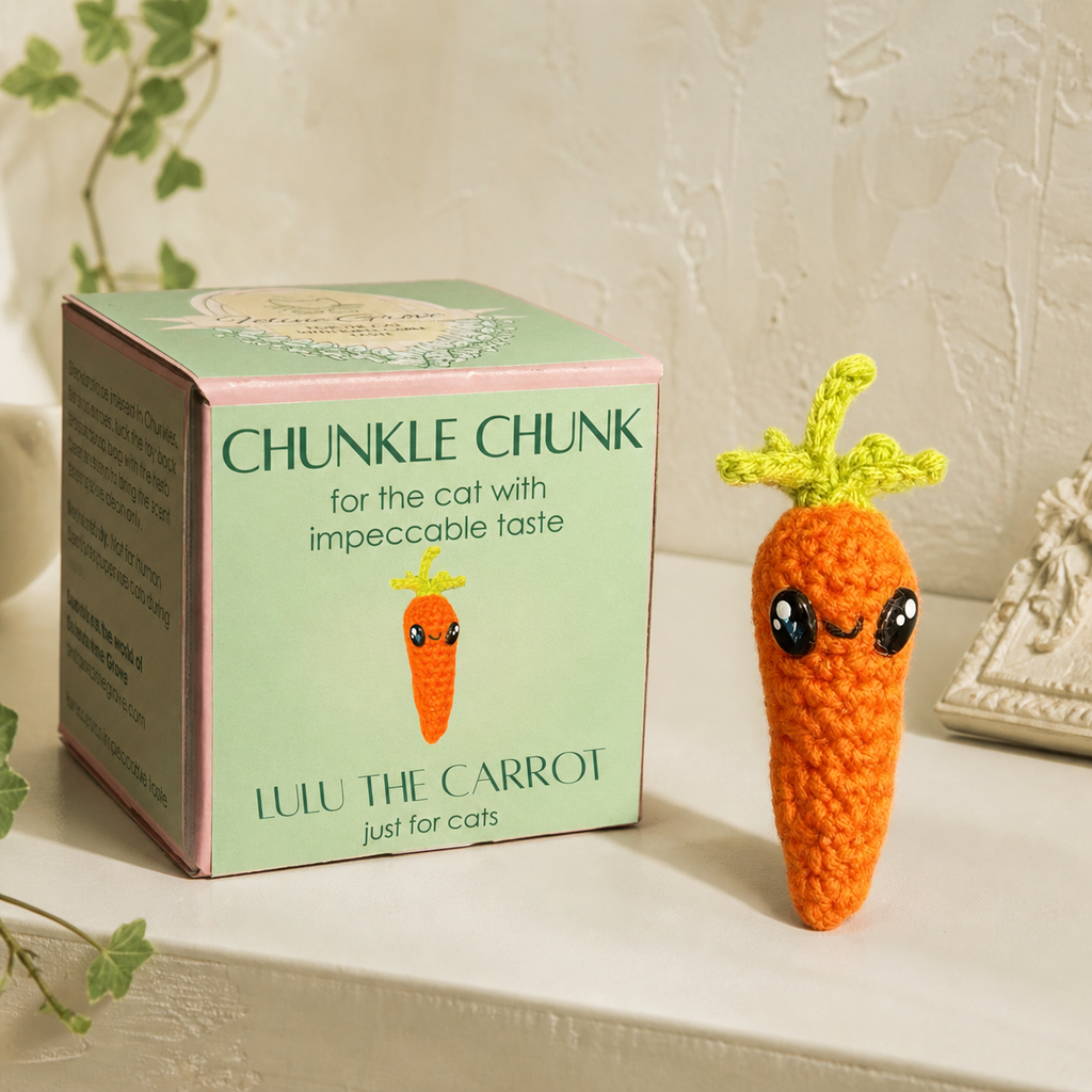 Cat toy carrot Chunkle Puff with box packaging with woven carrot cat toy displayed, bright orange body with green top and soft textured surface, compact shape for batting and carrying, Chunkle & Puff toy infused with Miracle Nip