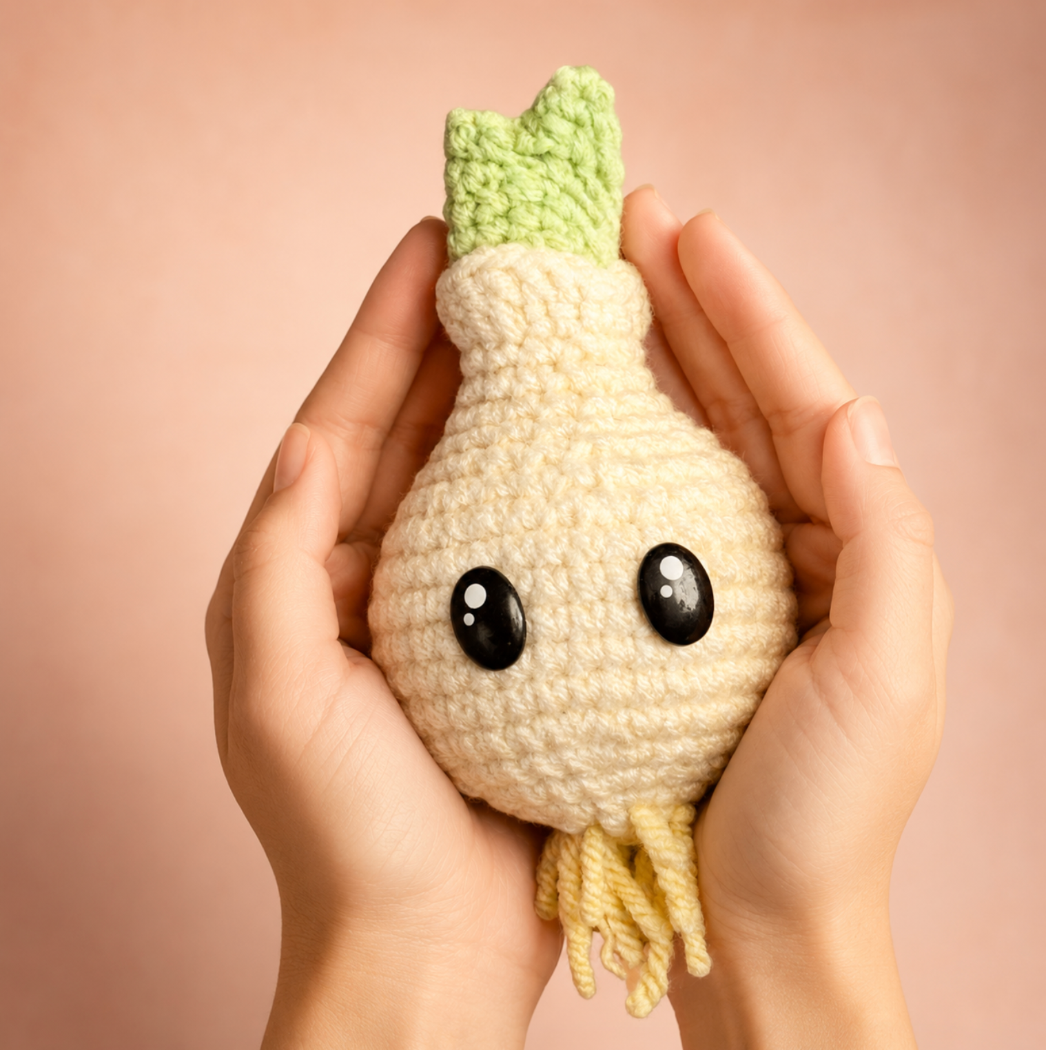 Corbin the Onion Chunkle Chunk by Chunkle & Puff, a woven independent play cat toy for indoor cats infused with Miracle Nip botanicals, shown resting in two hands to demonstrate size and texture.