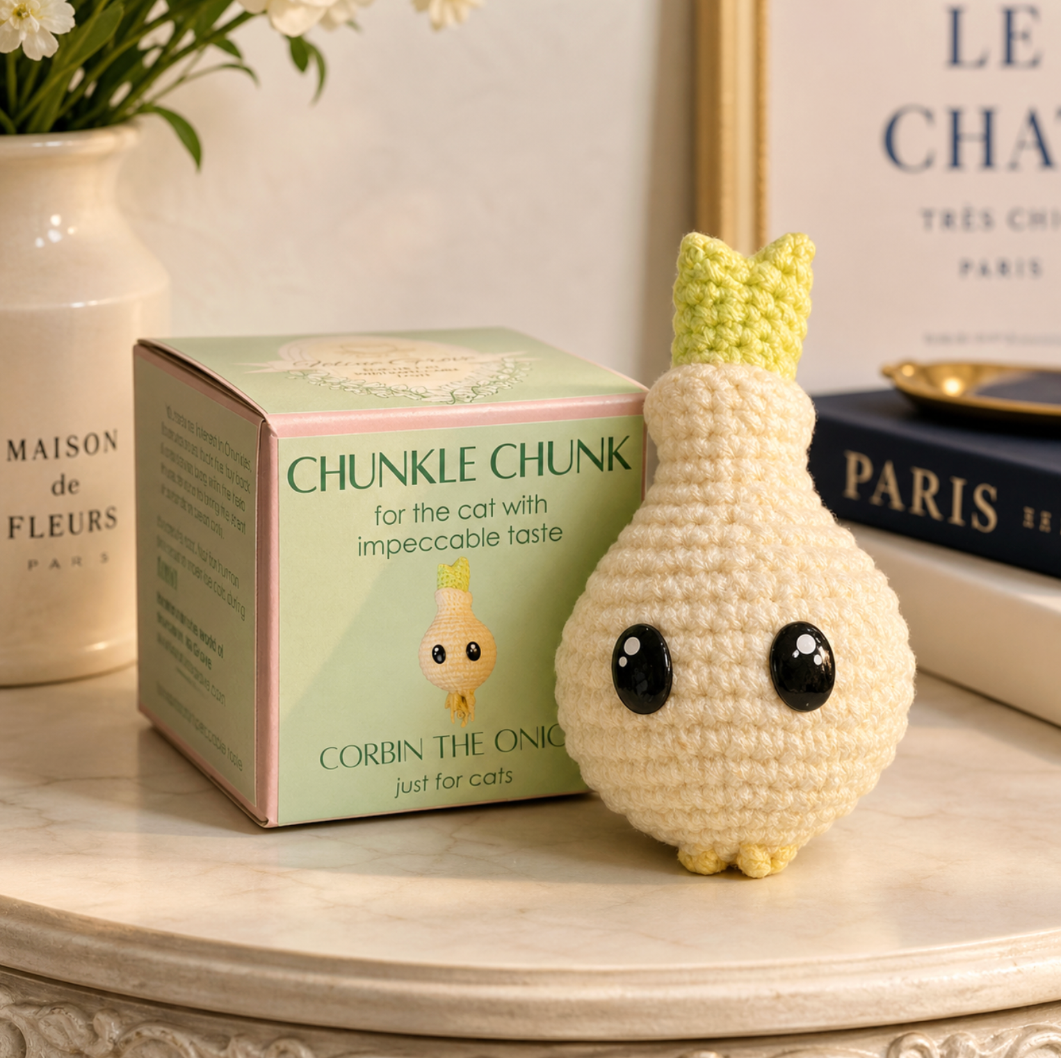 Corbin the Onion Chunkle Chunk cat enrichment toy by Chunkle & Puff displayed beside its green packaging box reading “Chunkle Chunk for the cat with impeccable taste.”