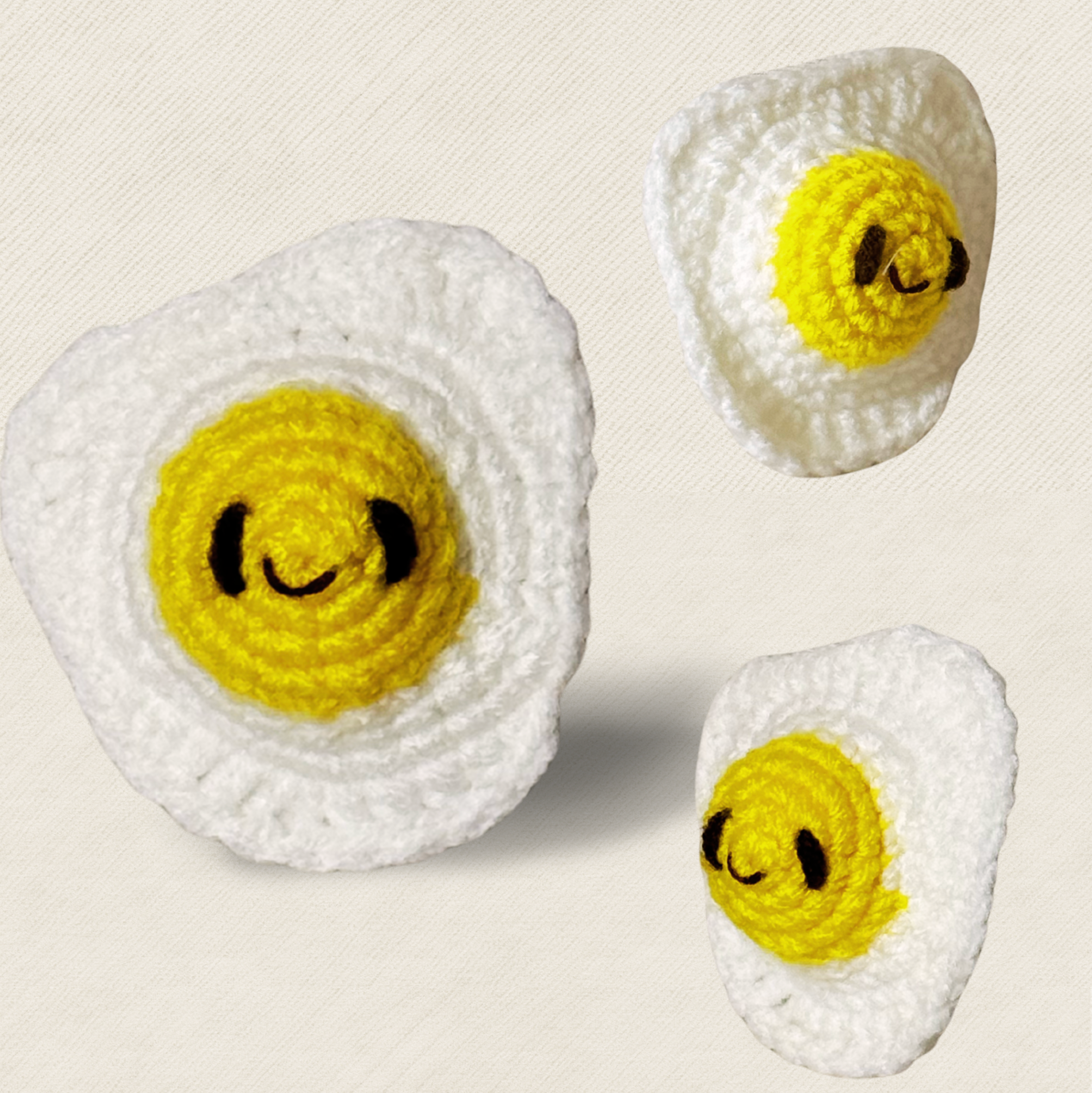 Celeste the Fried Egg Chunkle and Puff cat toy set in multiple sizes, woven egg shapes with yellow centers and white texture, independent play cat toys for indoor cats infused with Miracle Nip by Feline Grove including silvervine and valerian