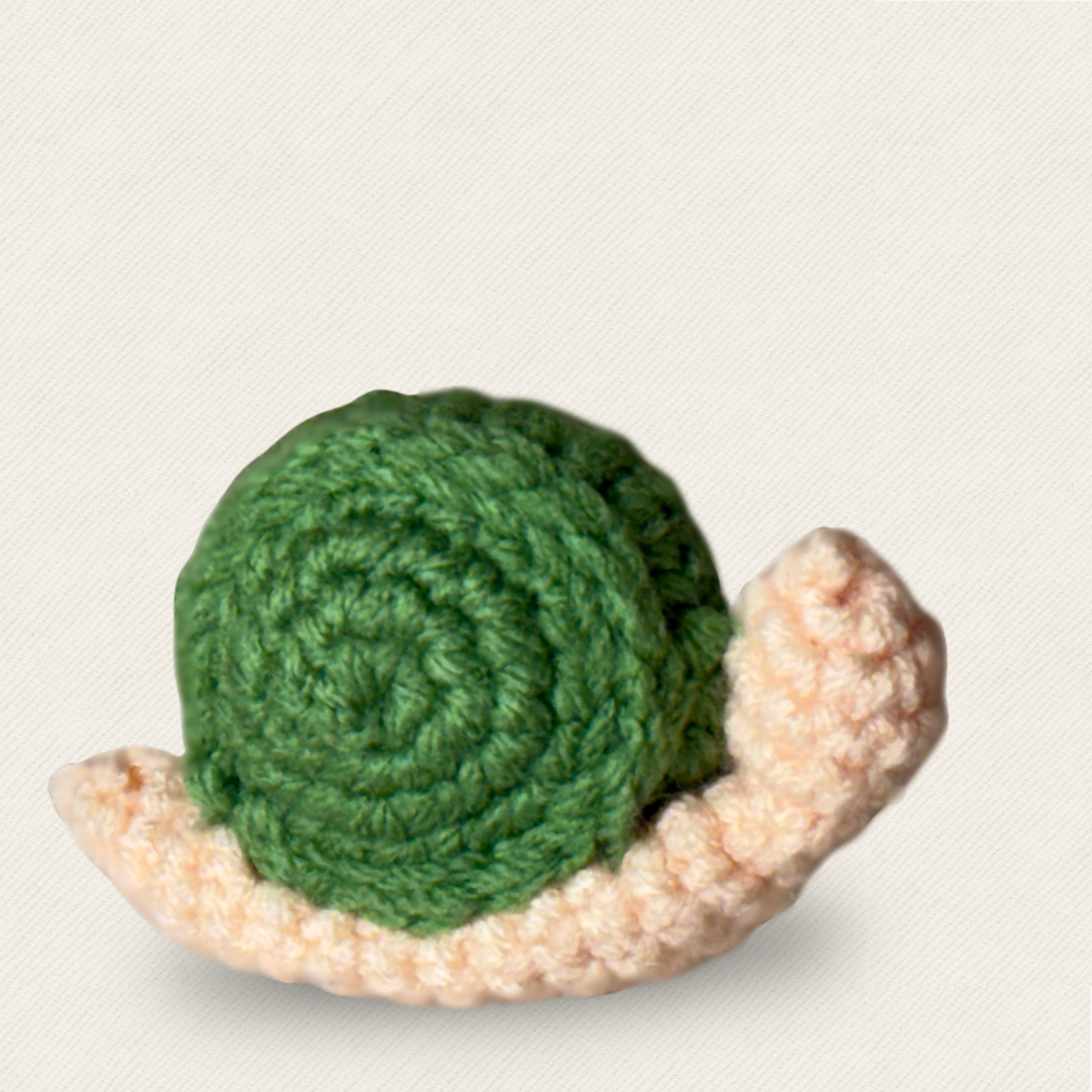 Close-up of woven snail cat toy with green spiral shell and soft textured body, compact lightweight form designed for batting and tossing, artisan Chunkle & Puff toy infused with Miracle Nip