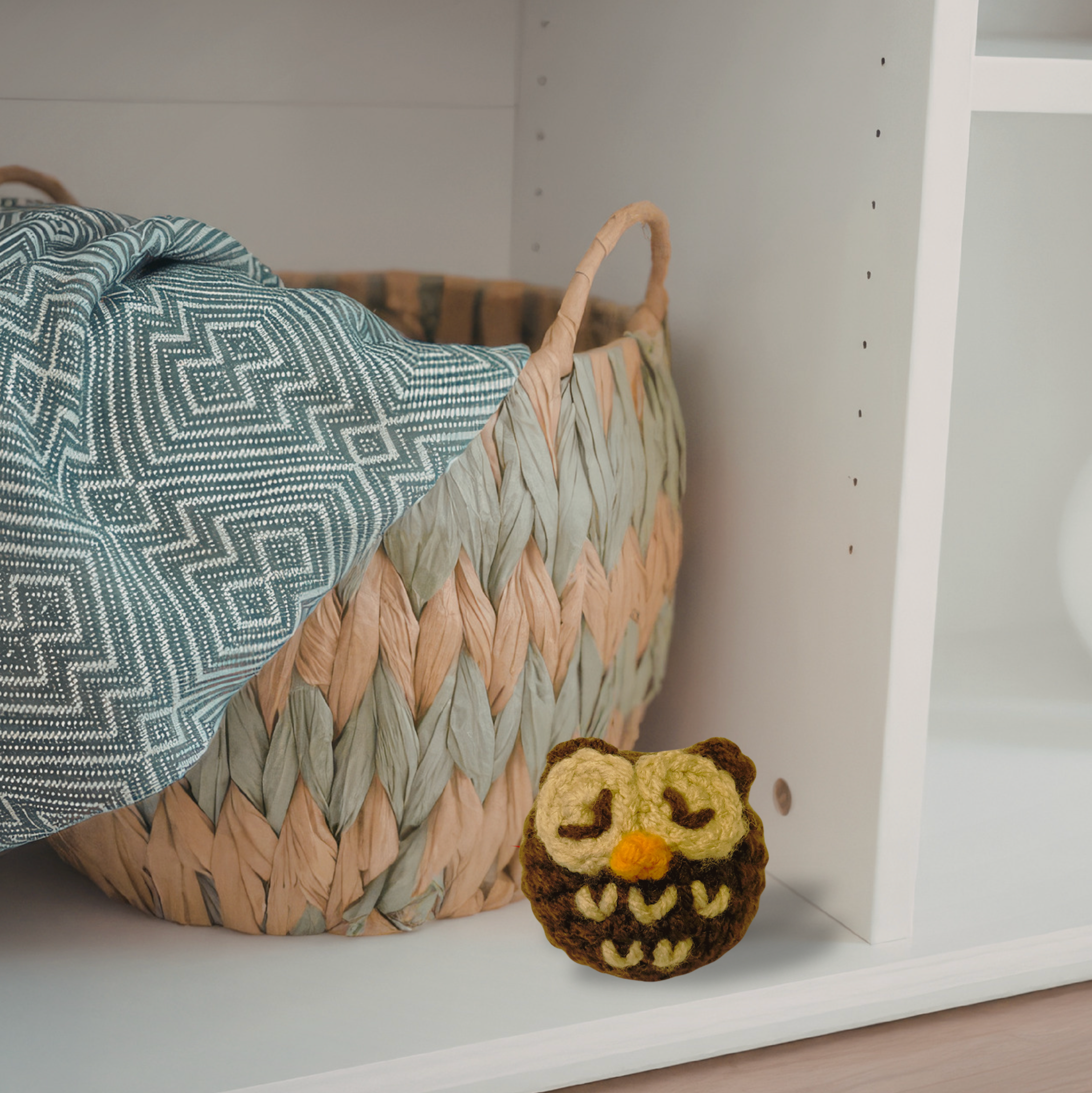 Brown owl silvervine cat toy by Chunkle & Puff on white shelf with wicker basket