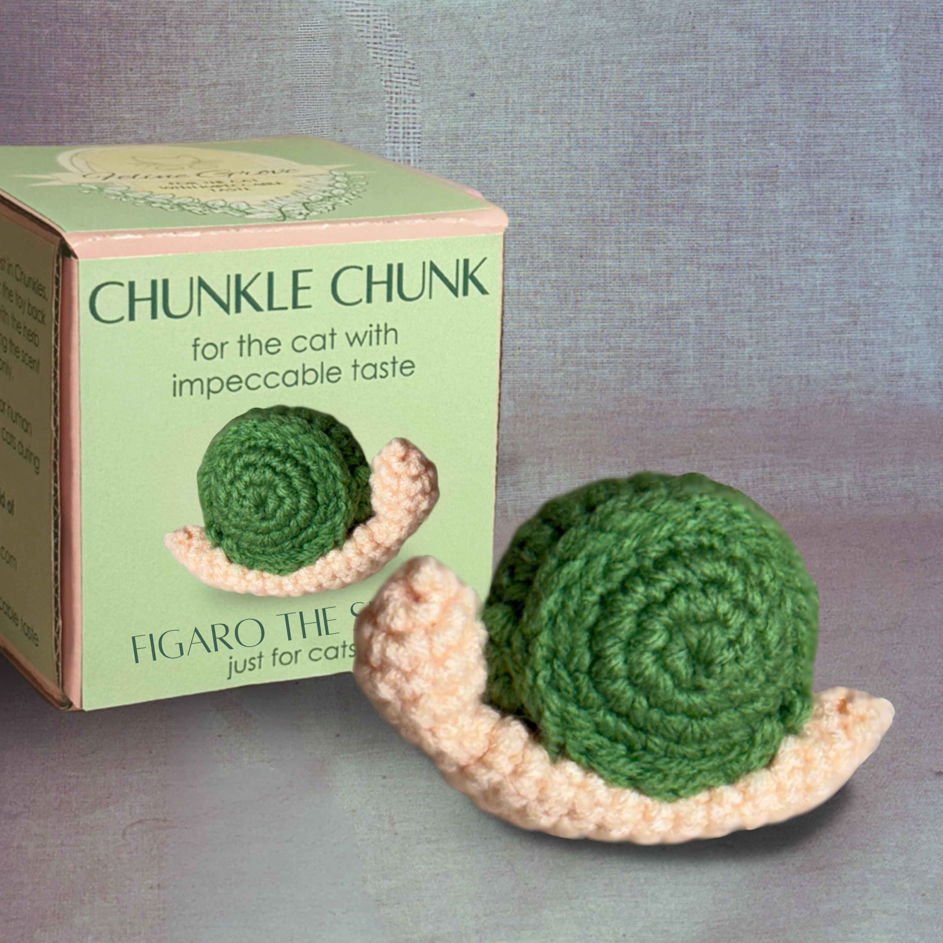Chunkle Chunk box packaging with woven snail cat toy displayed, green spiral shell and soft textured body, compact form for batting and carrying, Chunkle & Puff toy infused with Miracle Nip