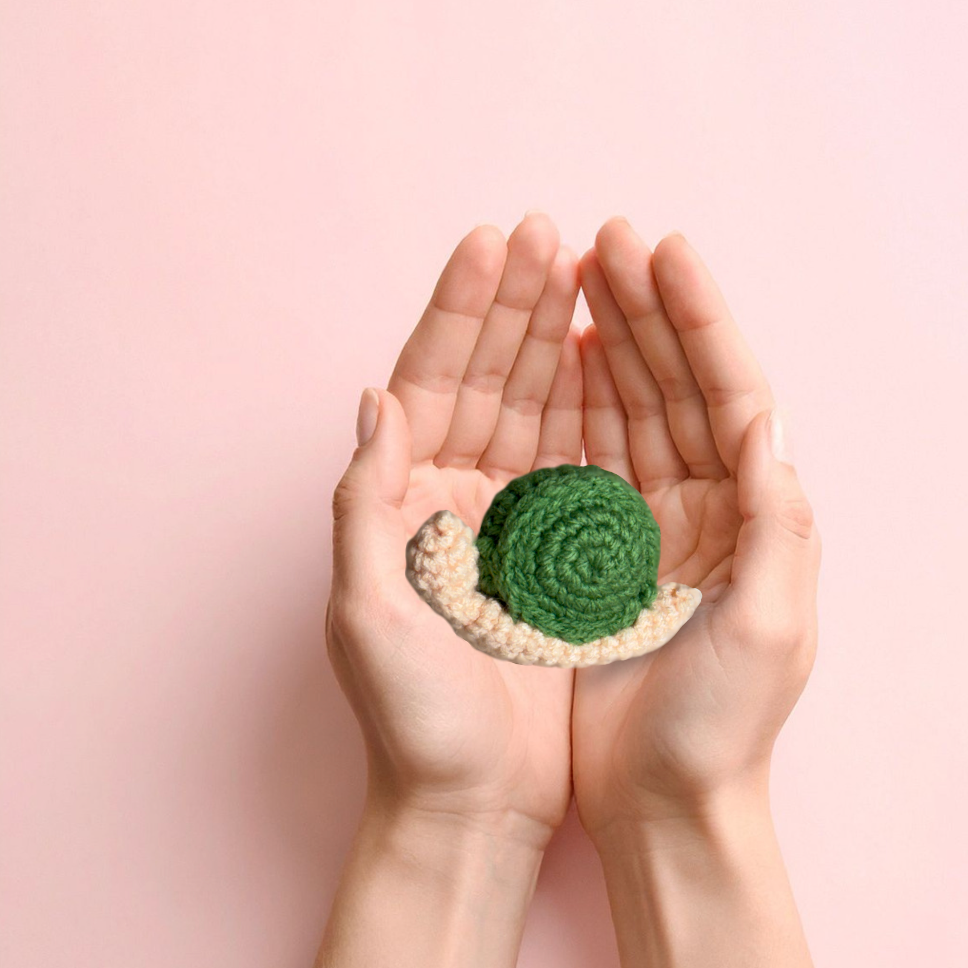 Artisan woven snail cat toy with green spiral shell resting in cupped hands, soft textured surface and small palm-sized scale, lightweight form for batting and carrying, Chunkle & Puff toy infused with Miracle Nip